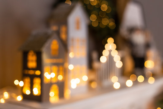Blured photo of christmas decorations standing in a row on fireplace