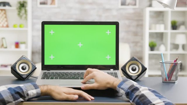 Man hands scrolling on laptop with green screen isolated mock up display