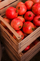 Ripe pomegranates in a basket at the market. Seasonal fruits