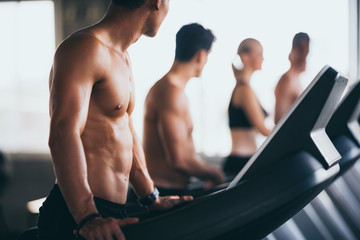 Fototapeta na wymiar People running in machine treadmill at fitness gym club