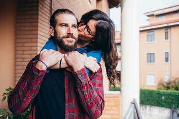 Young beautiful happy couple at home hugging