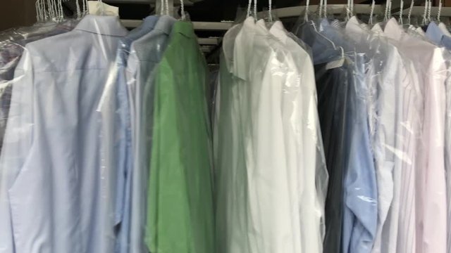Clean business shirts on rack in laundry