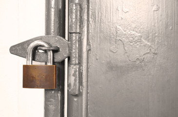 old rusty padlock on a old steel door
