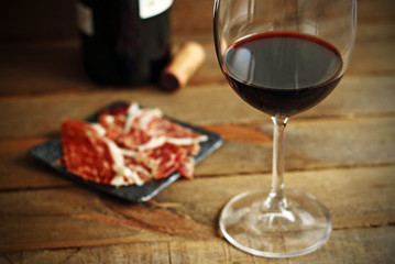 Spanish typical Iberian ham and red wine on wood