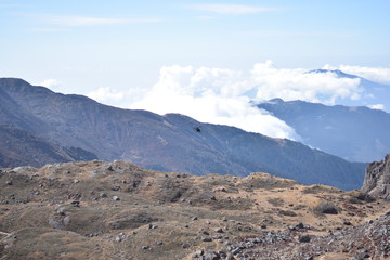 Helicopter flying between the mountains of the Langtang National Park, Nepal