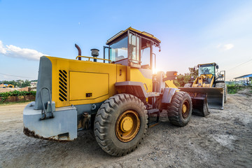 Big excavator on new construction site in the background the blue sky and sun