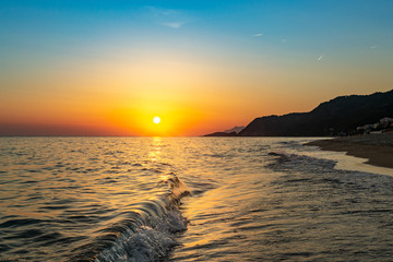Sunset over the ocean at the Vrachos beach in Greece