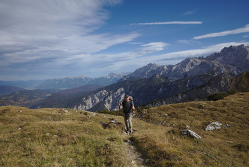 Fototapeta na wymiar NB__9829 Hiker with backpack and walking sticks on mountain path