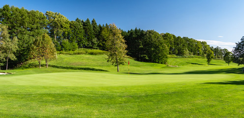 Panorama View of Golf Course with beautiful putting green. Golf course with a rich green turf beautiful scenery.