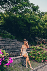 Chinese tourist walking and discovering nature on Asia vacation tourism. Caucasian beautiful woman in hat with backpack.  Travel lifestyle concept. Tropical resort in Sanya, Hainan, China