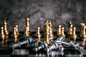 Gold and Silver Chess on chess board game for business metaphor leadership concept