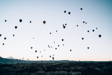 Hot air balloons landing in mountains