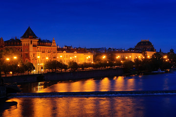 Obraz premium Vltava river in night, Prague in Czech Republic. Twilight view of Prague with rose-orange sky, Smetanovo nabrezi, Prague, travelling in Europe