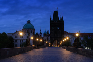 Prague, Charles Bridge in night. Lights on the bridge, built in medieval times. Twilight view of Prague with blue sky. Travelling in Europe. Town Prague, capital of Czech Republic, old city.