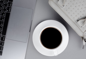 Top image of coffee mugs and laptops with leather bags.