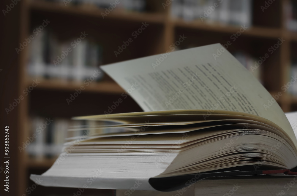 Poster stack of books in the library and blur bookshelf background