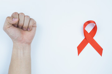 Aids awareness, male hands stranglehold and red AIDS awareness ribbon on white background. World Aids Day, Healthcare and medical concept.