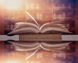 The blurred book that is bewitched with magic, the magic light in the dark, with the bright light shining down as the power to search for knowledge. For research and use as a blurred background