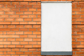 carrot color brick wall - empty white poster, copy space.