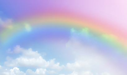 There are clouds and sky with rainbow as pastel background.