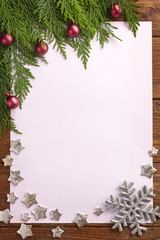 Fototapeta na wymiar Holiday Christmas card with fir tree and festive decorations balls, stars on wood background. Christmas template for banner, ticket, leaflet, card, invitation, poster