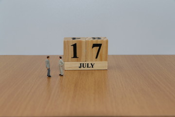 July 17, a calendar photo from the wood The table top consists of a book and pen that is ready to use. White background