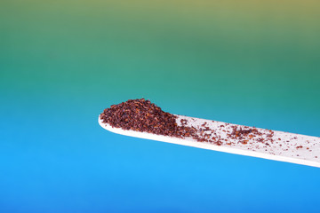 Sumac spice with macro lens photographed against colorful gradient in studio