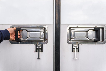Man hand opening a truck freezer door