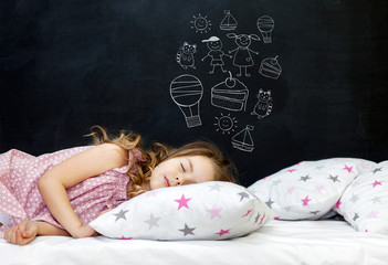 Charming little girl of preschool age sleeps in bed on a pillow with stars. Time to sleep. Drawing about the dreams of a child: kitten, dessert, adventure and friendship. Copy space