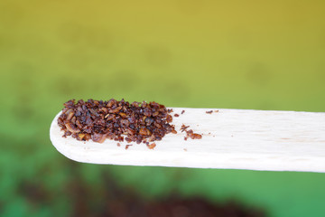 Sumac spice with macro lens photographed against colorful gradient in studio