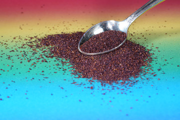 Sumac spice with macro lens photographed against colorful gradient in studio