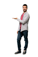 Full-length shot of Handsome man with beard presenting an idea while looking smiling towards over isolated white background