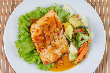 Salmon fillet in citrus sauce, fried plantain and vegetables