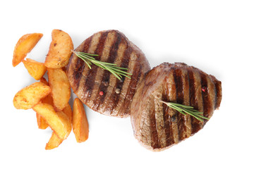 Delicious grilled beef medallions with fried potatoes isolated on white, top view