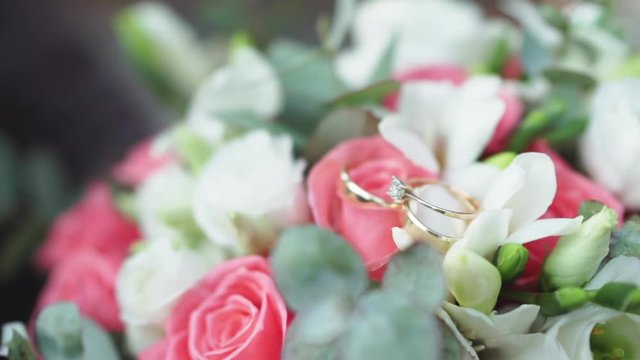 Wedding rings lying on a bouquet of flowers