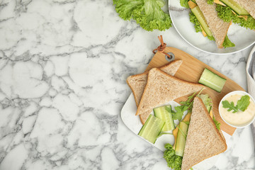 Fototapeta na wymiar Flat lay composition with tasty sandwich and ingredients on white marble table. Space for text