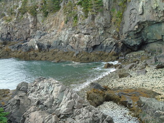 Rocky Maine Coast with the Atlantic Ocean reflecting off the water as it washes ashore
