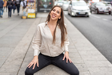Fototapeta premium Girl sitting on a street bench