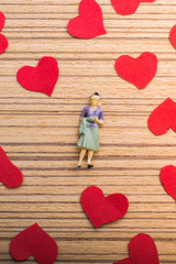 Woman figurine and Love concept with paper hearts