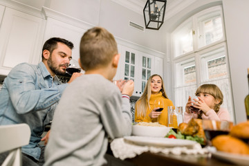 family, holidays, thanksgiving, generation and people concept - smiling family having dinner at home