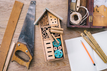 Making wooden insect house - Powered by Adobe