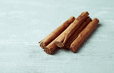 Ceylon cinnamon sticks on wooden background. Natural spices