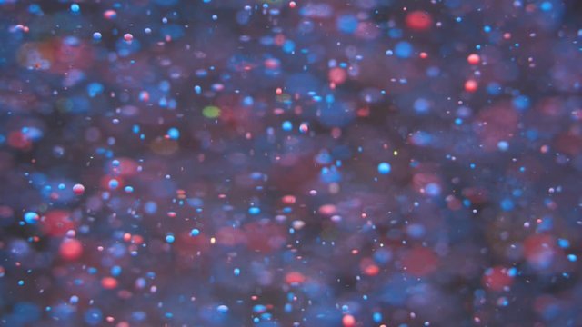 Bright Festive Background. Chaotic Motion Particles. Colorful Bubbles Oil Beautiful Paint Multi Colored Universe Moving. Space Galaxy Planets. Surface Slow Motion. Bokeh Holiday Christmas Background.
