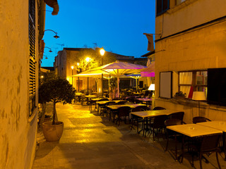 restaurants on the public market place in the lanes of the old town of Alcudia Majorca by night