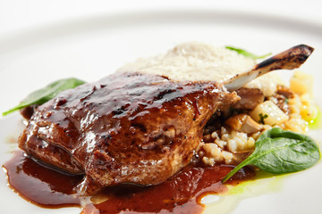 Duck leg with millet and hummus dish