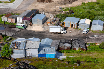 Russia, Arctic, Kola Peninsula, Barents Sea, Teriberka: Aerial view of Lodeiny, the newer part of the old Russian settlement small fishing village with run down houses buildings garages.