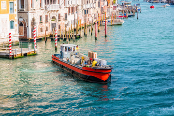 Fototapeta na wymiar Working boat on Venetian canal in Venice, Italy