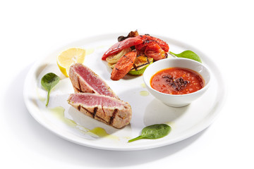 Tuna steak with grilled vegetables closeup