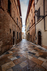 Naklejka na ściany i meble Volterra medieval town Picturesque houses Alley in Tuscany Italy