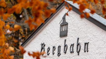 colorful autumn leaves in the harz forest with the bad harzburg bergbahn sign, germany